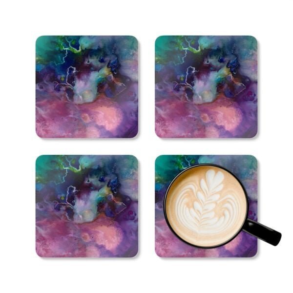 Abstract watercolor coaster set shown with coffee mug for scale.