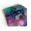 Abstract watercolor coaster set stacked on a table.