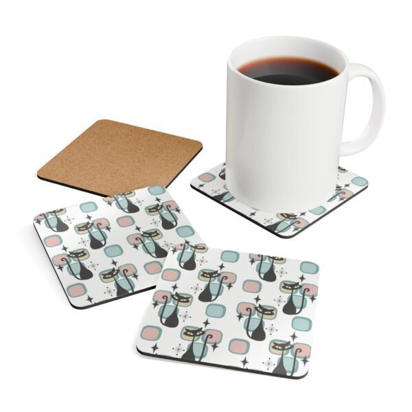 Mid‑century modern atomic cat coaster shown with a mug for scale.