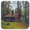 Square coaster with an image of a log cabin in a forest printed on it.
