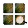 Set of 4 coasters with an image of a large green tree in the forest printed on them. Shown with a mug for scale.