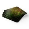 Set of 4 coasters with an image of a large green tree in the forest printed on them. Shown stacked on a table.