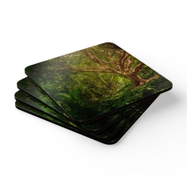 Set of 4 coasters with an image of a large green tree in the forest printed on them. Shown stacked on a table.