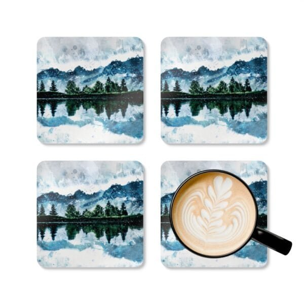 Coaster set with watercolor art print of a mountain, trees and a lake. Shown with a mug for scale.