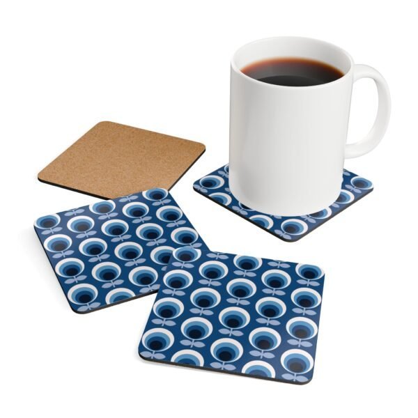 Set of 4 square coasters with a blue and white mid century modern circle print design. Shown with a mug for scale.