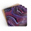Set of 4 coasters with abstract art print in shades of red, purple, black and white. Stacked on a table.