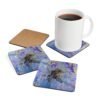 Set of 4 coasters with abstract art print in shades of purple, black and gold. Shown with a mug for scale.
