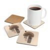 Set of four square coasters with minimalist neutral design in shades of brown, tan and black. Shown with a mug for scale.