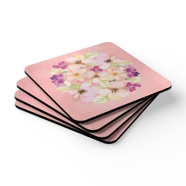 Set of 4 pink watercolor style floral coasters stacked on a table.