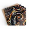 Set of 4 square coasters with a mosaic design in black and amber colors printed. Shown stacked on a table.