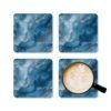 Blue and white marble print coaster set shown with mug for scale.