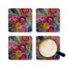 Coasters with image of colorful embroidered boho flowers shown with a mug for scale.