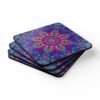 Colorful radiant mandala coaster shown stacked on a table.