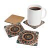 Set of 4 square coasters with image of a red, navy blue and turquoise mandala print. Shown with a mug for scale.