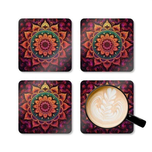 Set of 4 square coasters with image of a bright hot pink, orange and yellow mandala printed on them. Shown with a mug for scale.
