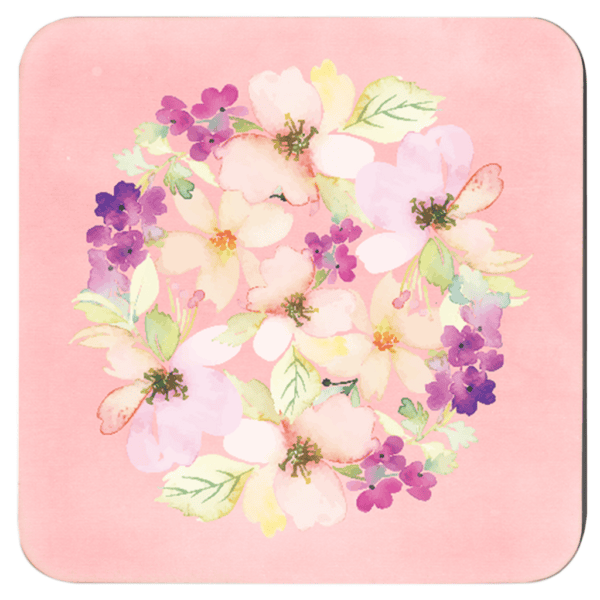 Pink watercolor floral coaster on table.