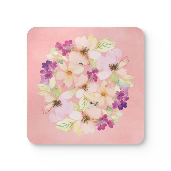 Pink watercolor floral coaster on table.