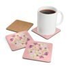 Set of 4 pink watercolor style floral coasters shown with a mug for scale.