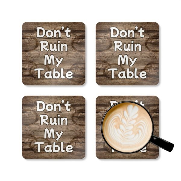 Set of four square coasters with image of wood with water rings on it and text that says 'Don't Ruin My table'. Shown with a mug for scale.