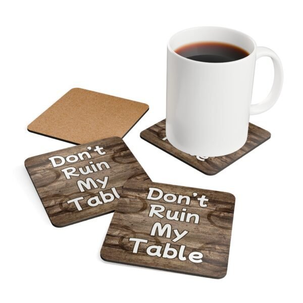 Set of four square coasters with image of wood with water rings on it and text that says 'Don't Ruin My table'. Shown with a mug for scale.