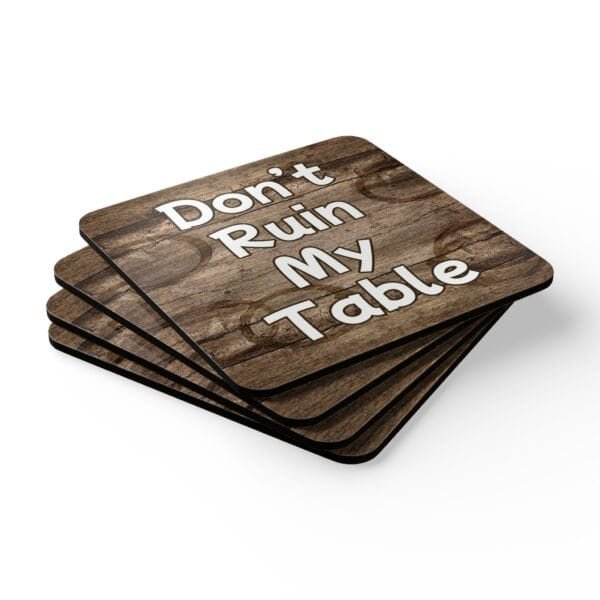 Set of four square coasters with image of wood with water rings on it and text that says 'Don't Ruin My table'. Shown stacked on a table.