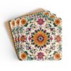 Set of coasters with a boho style floral medallion design with sunflower in the center.