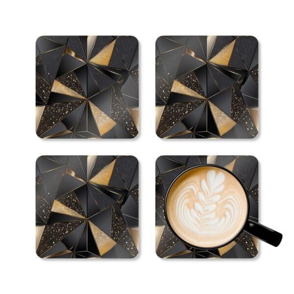 Set of 4 square coasters with a triangle geometric design in black and gold with some gold glitter effect printed on them. Shown with a mug for scale.