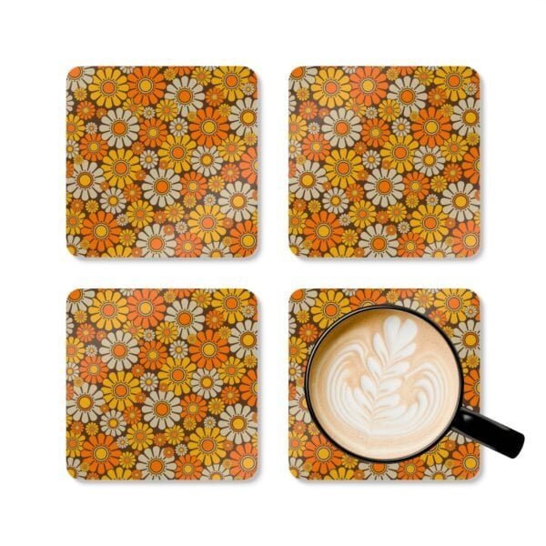 Set of 4 square coasters with 1960's hippie style daisy pattern in orange, yellow, brown and off white colors. Shown with a mug for scale.