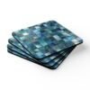 Colorful square mosaic design in shades of turquoise and teals coaster flat on table.