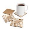 Set of four square coasters with neutral tan, beige and soft brown abstract shapes printed on them. Shown with a mug for scale.