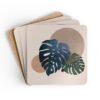 Set of four square coasters with a neutral boho design with Monstera leaves. Shown stacked on a table.