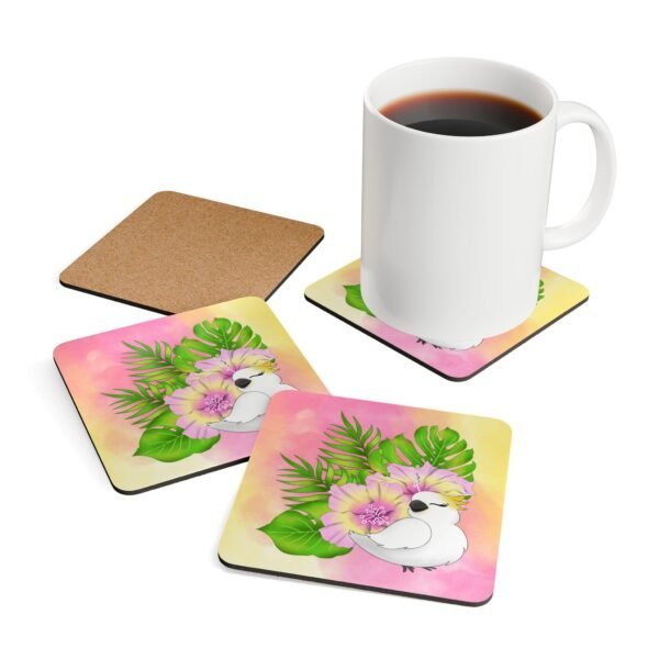 Set of four square coasters with an image of a cute white cockatoo parrot and a pink and yellow watercolor background. Shown with a mug for scale.