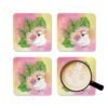 Set of four square coasters with an image of a cute white cockatoo parrot and a pink and yellow watercolor background. Shown with a mug for scale.