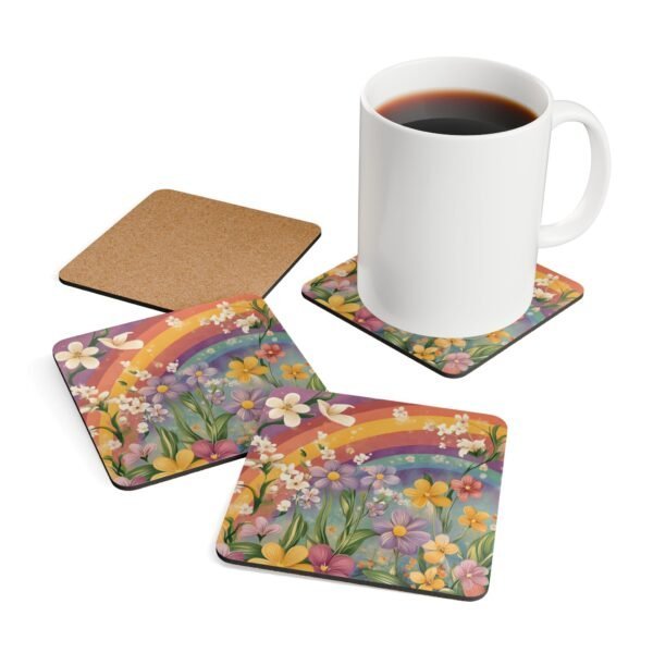 Set of coasters with pastel rainbow colors floral print with a rainbow in the background. Shown with a mug for scale.
