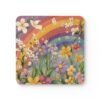 Set of coasters with pastel rainbow colors floral print with a rainbow in the background. Shown stacked on a table.