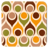 Square coaster with mid century modern circle design in tan, brown, orange and olive green.