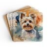 Set of four square coasters with a watercolor style image of a Yorkie dog printed on them. Shown stacked on a table.