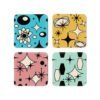 Four mid‑century modern coasters arranged in a square. Each coaster has a different pastel background color with black atomic‑style geometric shapes. The top left coaster is aqua, the top right is dusty rose, the bottom left is golden yellow, and the bottom right is mint. All four designs include small cream‑colored open spaces within the shapes.