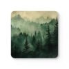 Square coaster with image of misty green and grey forest landscape with layered trees fading into soft mountain fog.