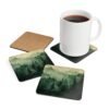 Set of four square coasters with image of misty green and grey forest landscape with layered trees fading into soft mountain fog.