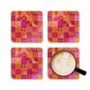 Stack of square cork‑backed coasters featuring a bold geometric pattern in pink, orange, and red tones. The design includes circles, triangles, and abstract shapes arranged in a retro grid style.