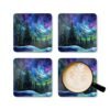 Square coaster set featuring a stained‑glass style design of evergreen trees under swirling aurora lights in shades of blue, green, and purple. Shown with a mug for scale.